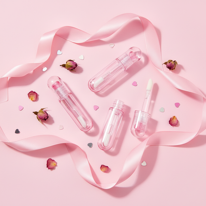 Pink glitter heart lip gloss tubes gift flatlay with ribbon and rose petals