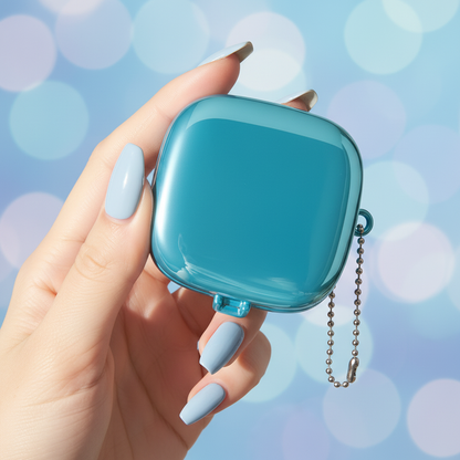 Hand holding metallic blue square eyeshadow palette case with ball chain