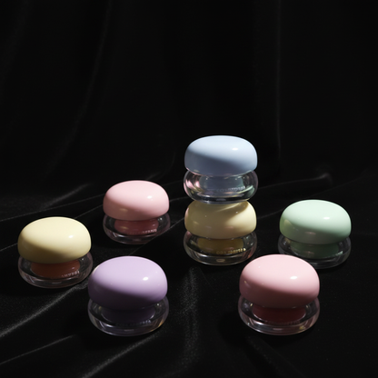 Round mushroom cap lip mask jars all pastel colorways on black velvet scene