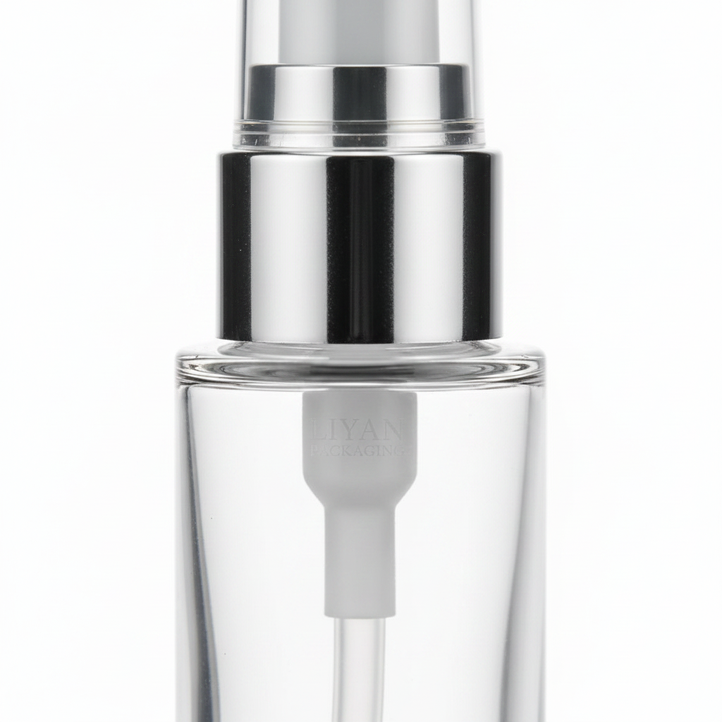 Glass pump bottle detail - silver pump head close-up