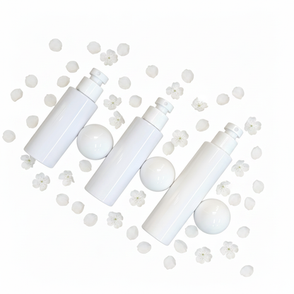 Three white ball cap bottles flat lay with white flower petals