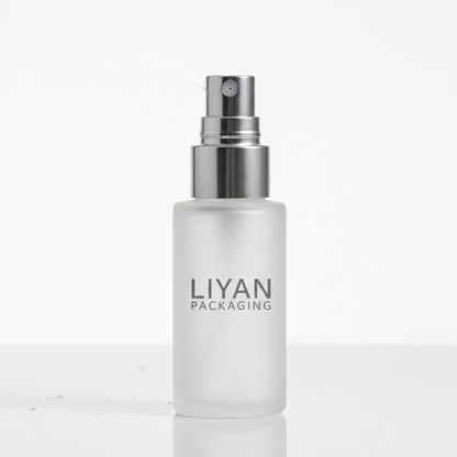 Close-up of silver fine mist pump nozzle on frosted spray bottle