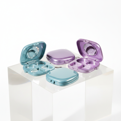 Pearl blue and purple eyeshadow palette cases open on acrylic podium showing 4-pan interior