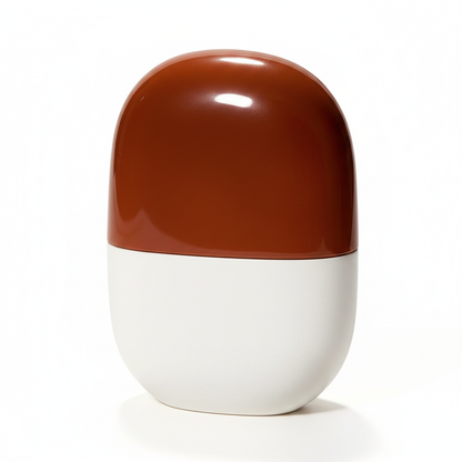 Capsule pill-shaped brown white squeezable cosmetic bottle hero shot white background